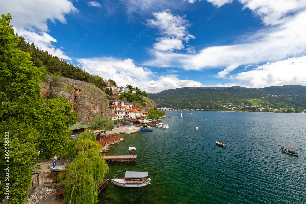Ohrid lake, North Macedonia. Peaceful lake in spring. Small houses are spread over a cliff near path leading to the Saint Johan at kaneo church in Macedonian town ohrid