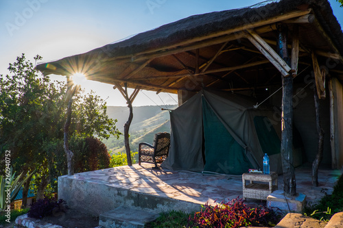 Luxury tent in national park with sunset view over mountains, Uganda, Africa