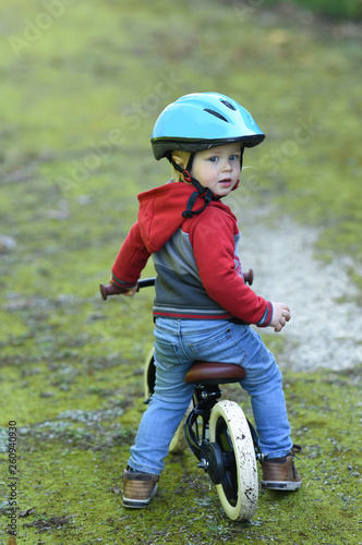Fototapeta Naklejka Na Ścianę i Meble -  child on a bike with a helmet