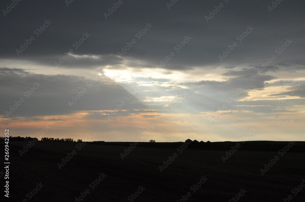 Sunlight Rays over Farm Silhouette