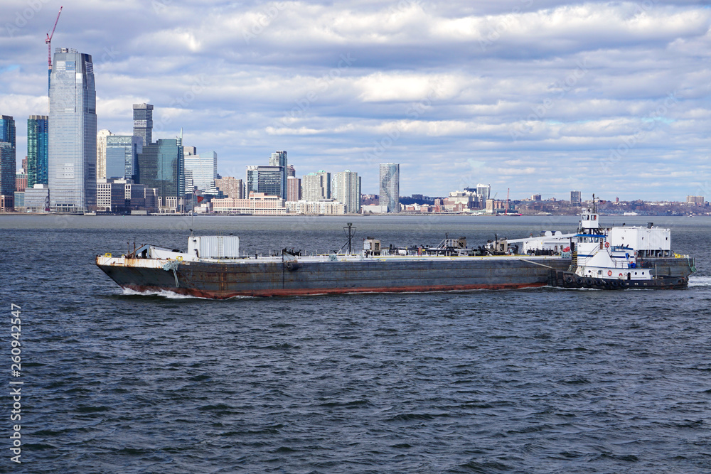 Tugboat pushing a barge in New York Harbor