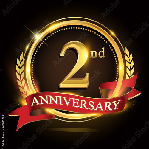2nd golden anniversary logo, with shiny ring and red ribbon, laurel wreath isolated on black background, vector design for birthday celebration.