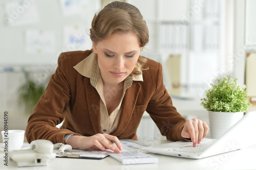 Portrait of cute young businesswoman at her working place