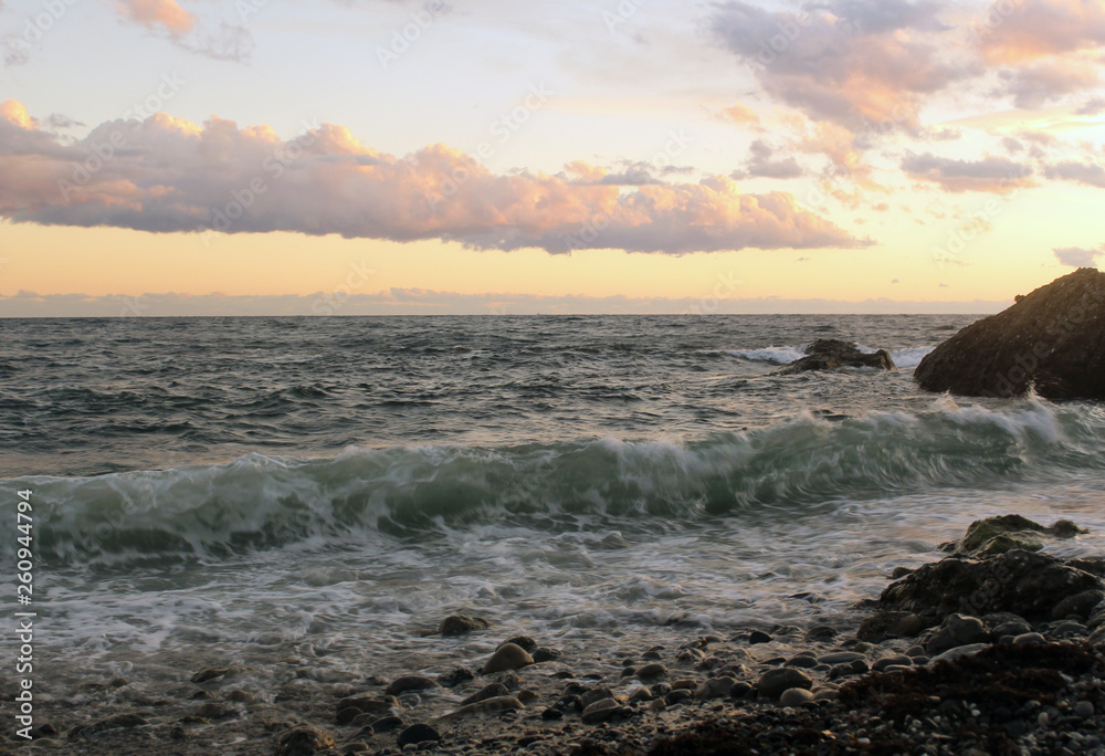 Big the waves hit the shore. Seashore at sunset.