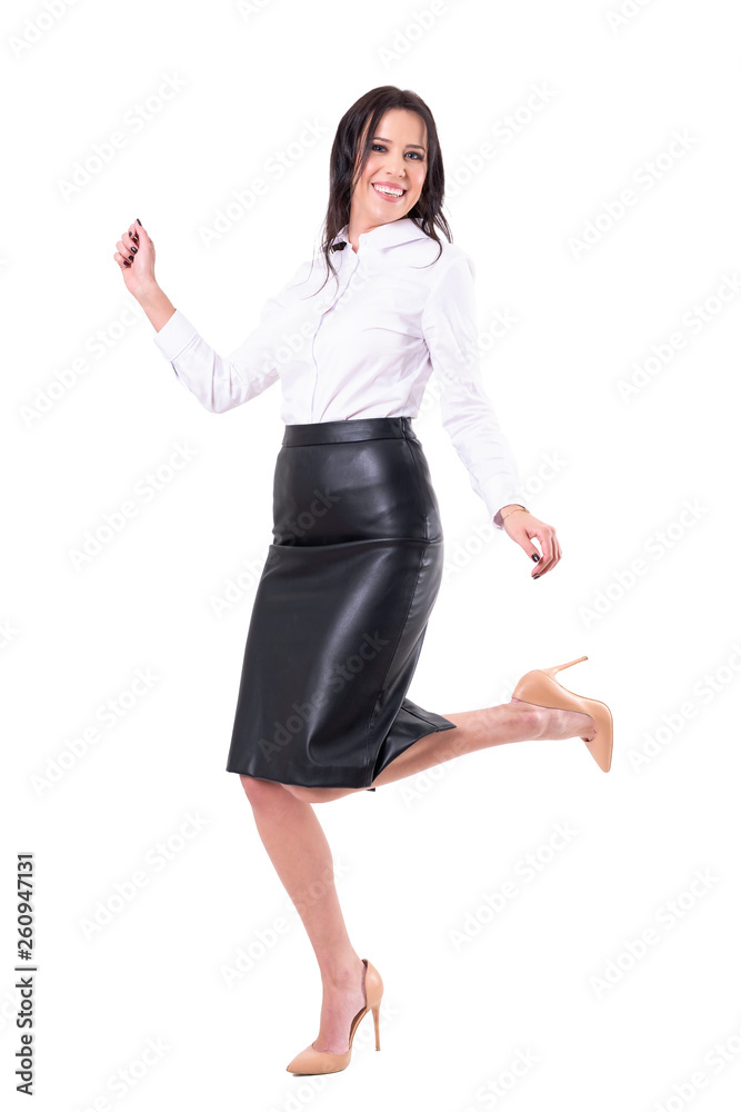 Cheerful ecstatic young business woman jumping dancing and celebrating success. Full body isolated on white background. Cheerful ecstatic young business woman jumping dancing and celebrating success. Full body isolated on white background.