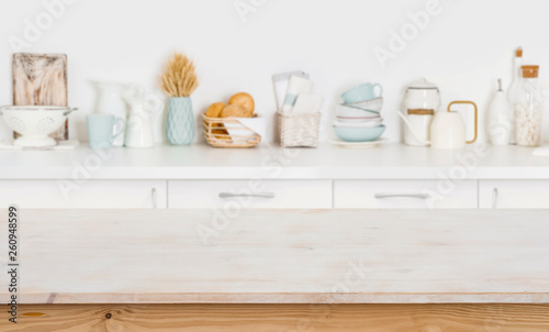 Wooden table on blurred kitchen counter background with cooking ingredients