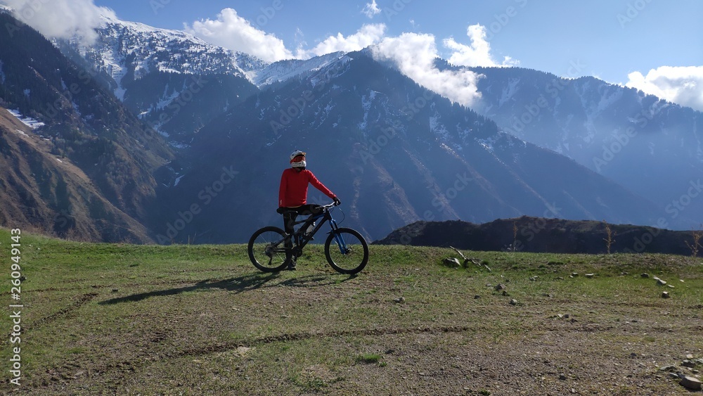 mountain biker in mountains, downhill.