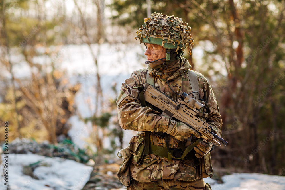 British special forces soldier with weapon take part in military maneuver. war, army, technology and people concept. British special forces soldier with weapon take part in military maneuver. war, army, technology and people concept.