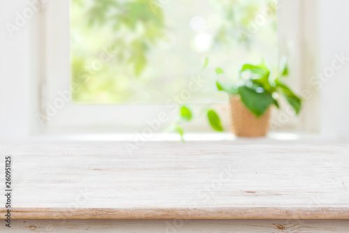 Light wooden texture table before defocused summer window background
