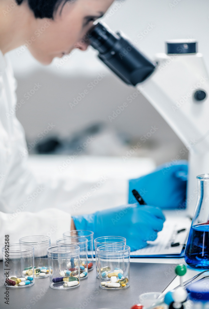 Fototapeta premium Medical Researcher Looking Through the Microscope