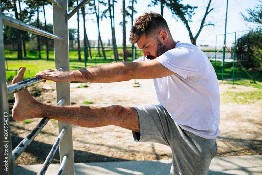 Young sports man training on the sports ground outside. Young sports man training on the sports ground outside.