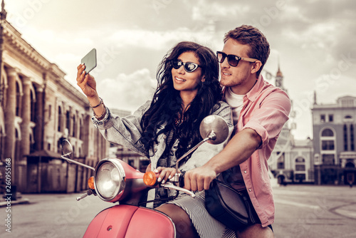 Cheerful young woman taking a selfie with her boyfriend