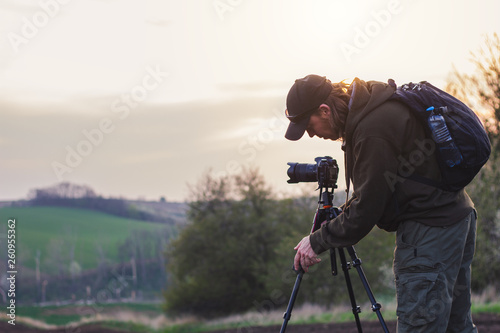 Landscape photographer setting tripod before taking picture