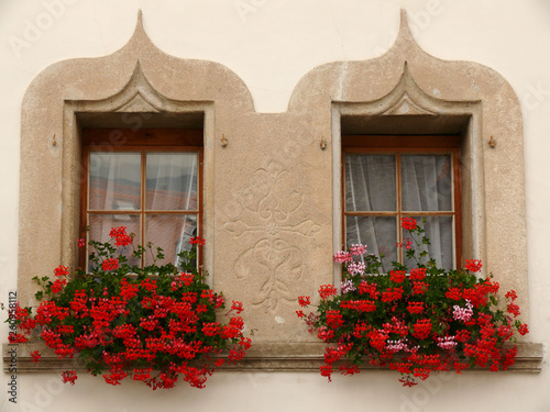 Gruyère, Switzerland. 07/30/2009. Twin windows with flowers.