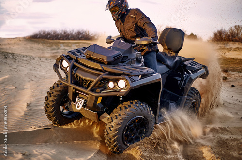 Racing in the sand on a four-wheel drive quad.