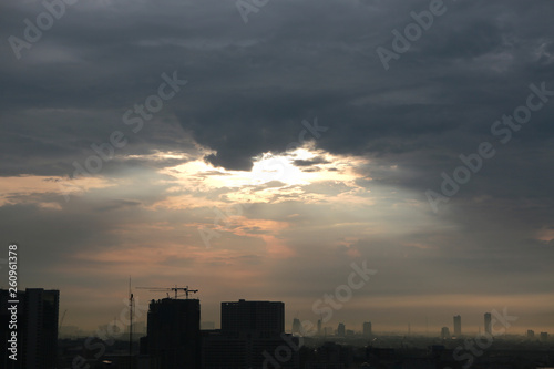 Sunset and clouds background in the evening, city downtown with sunset sky. © zilvergolf