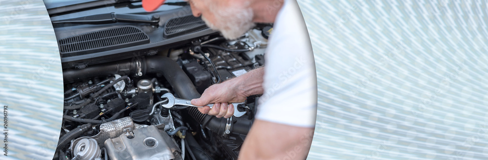 Car mechanic working on car engine. panoramic banner Car mechanic working on car engine. panoramic banner