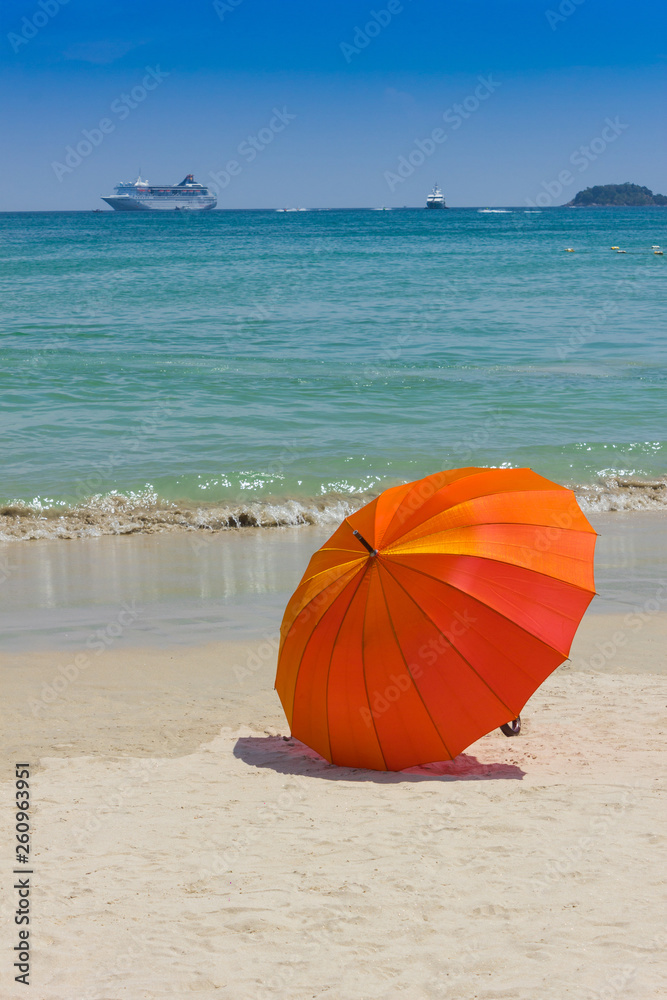 Orange umbrella on the beach