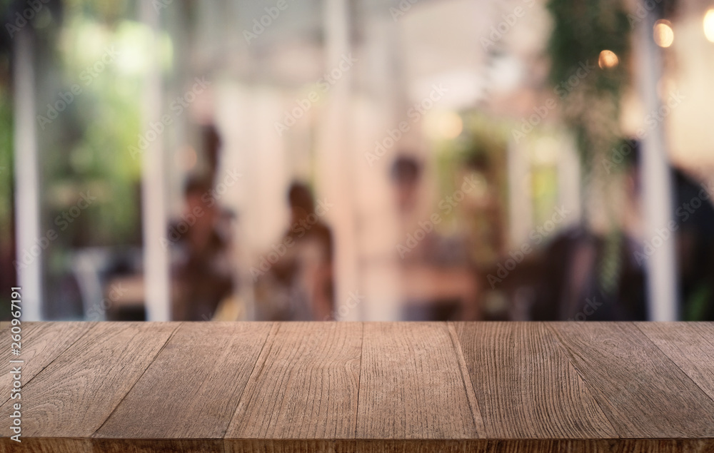 Empty dark wooden table in front of abstract blurred bokeh background of restaurant . can be used for display or montage your products.Mock up for space.