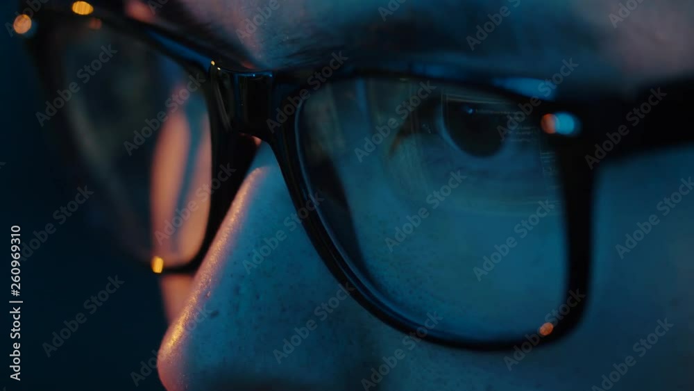 vision, hacking and technology concept - close up of hacker eyes in glasses looking at computer screen in darkness vision, hacking and technology concept - close up of hacker eyes in glasses looking at computer screen in darkness