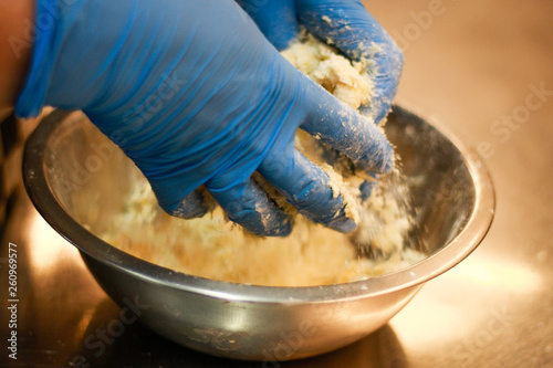 Girl chef kneading dough for eclairs. Plum, butter and flour.