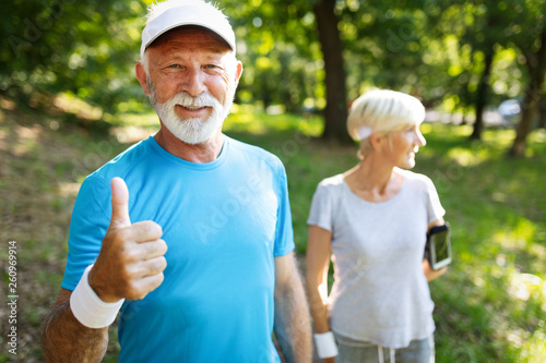 Fitness, sport, people, exercising and lifestyle concept - senior couple running