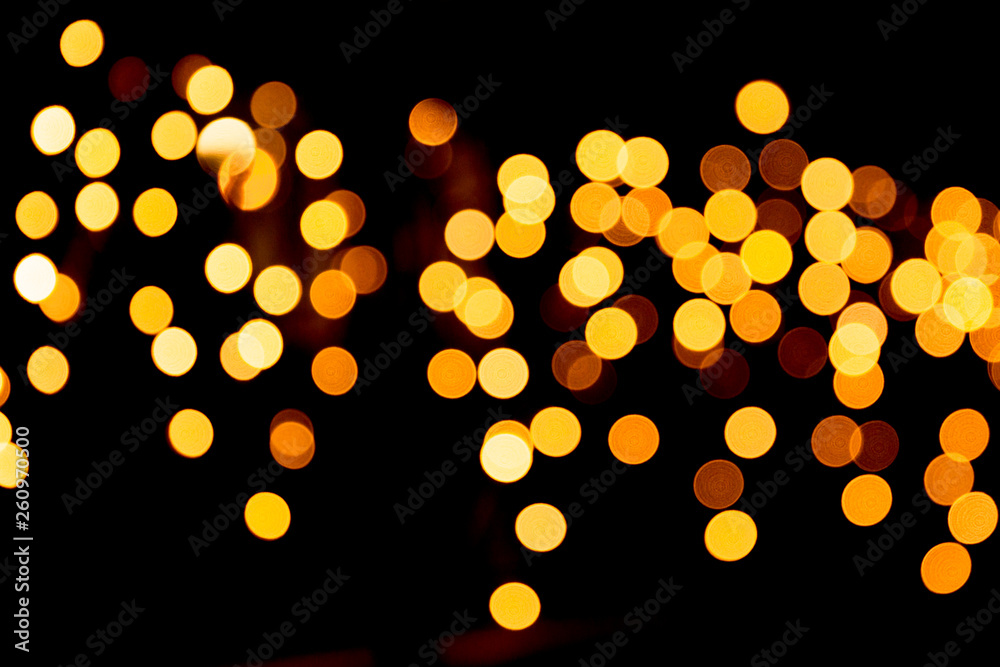 Festive abstract gold background with bokeh defocused and blurred many round yellow light on Christmas dark background - obrazy, fototapety, plakaty 