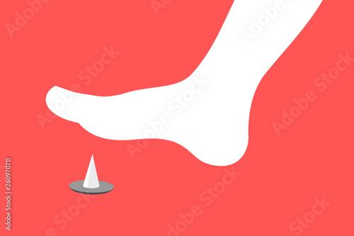 Barefoot foot is stepping on spiky pin and tack on the floor.. Danger and threat of painful injury and wound. 