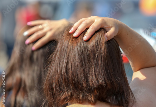 Girl holding hair on her head