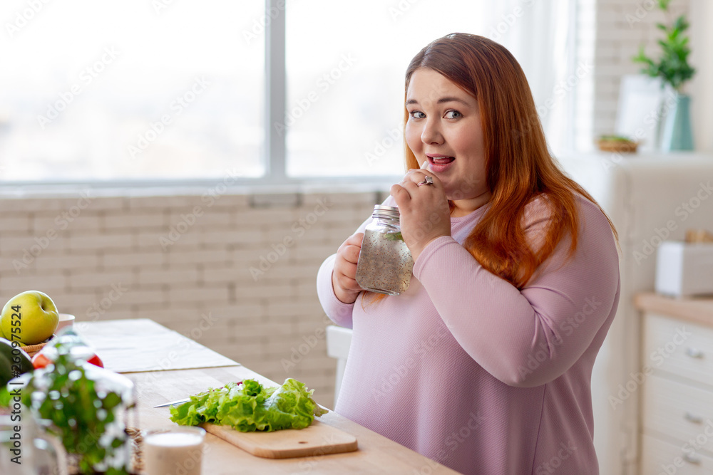 Positive nice woman having a healthy beverage Positive nice woman having a healthy beverage