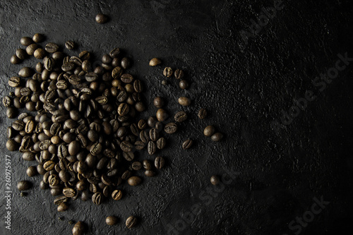 Coffee grains on black stone background