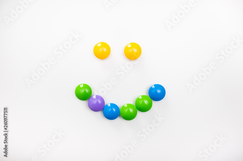 A smile made from children's toys. Multicolored figures for games