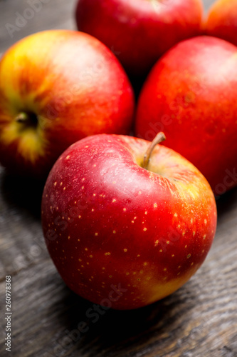 Close-up apples on the rustic wooden background. Selective focus. Shallow depth of field. 