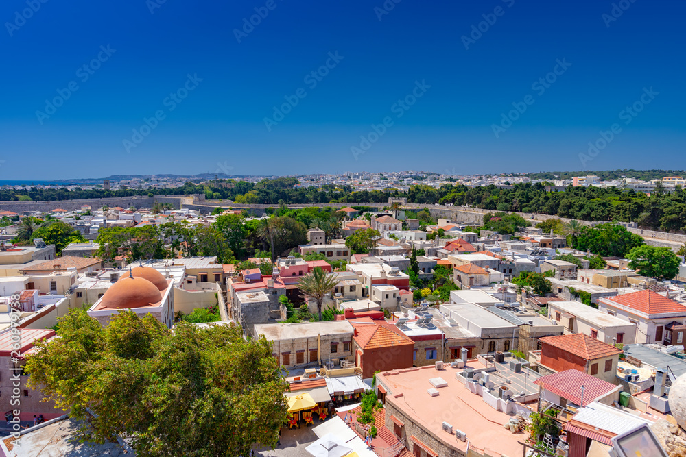 Panoramic view of the Rhodes medieval old city surrounded by ancient stone walls and the new town in the background. Rhodes island is a popular summer holiday destination in Dodecanese, Greece.