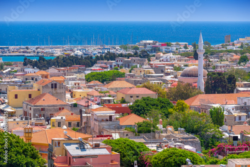 Panoramic view of the Rhodes medieval old city, with the historic Ibrahim Pasha Mosque and Camii on the right, and the Mandraki new harbour in background. Popular summer holiday destination in Greece.