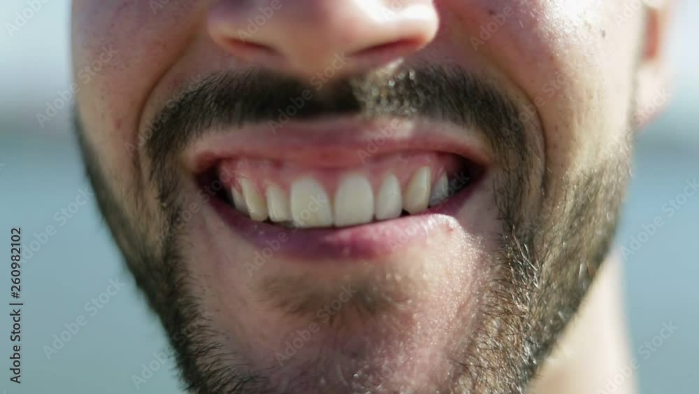 Cropped shot of male face with toothy smile. Handsome bearded guy smiling on camera. Face features concept Cropped shot of male face with toothy smile. Handsome bearded guy smiling on camera. Face features concept