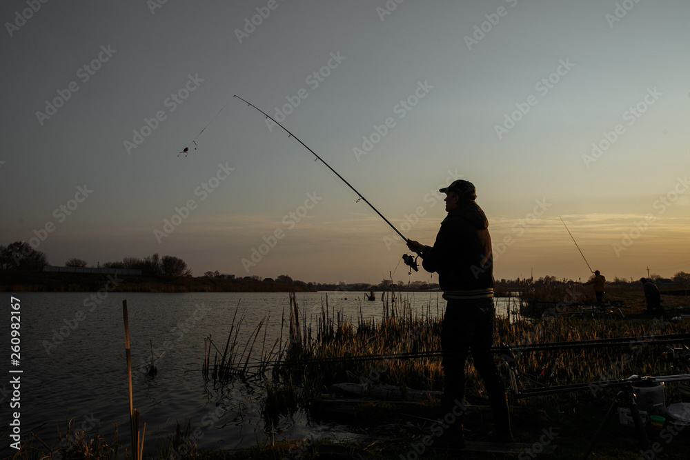 Silhouette of a fisherman against the sky