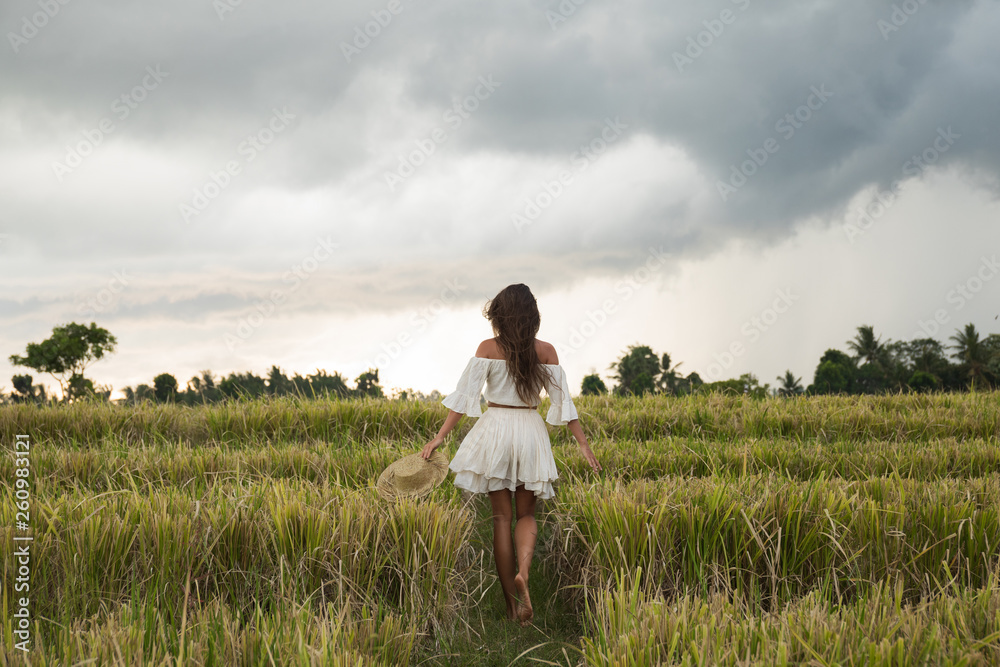 Carefree woman wearing straw hat in the rice field Carefree woman wearing straw hat in the rice field