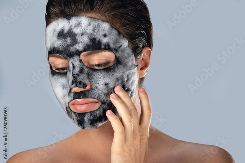 Obraz na plátně Woman with  bubble sheet mask on her face