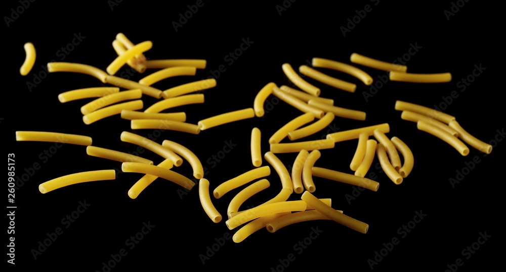 Farfalle pasta pile isolated on black background Farfalle pasta pile isolated on black background