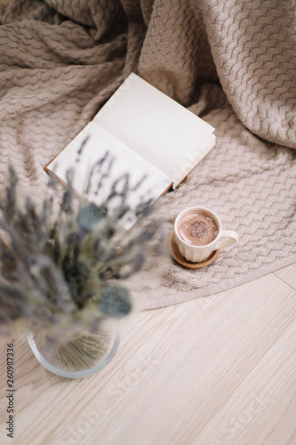 lavender bouquet with book and cup of coffee on wooden background. spring concept. top view. flatlay