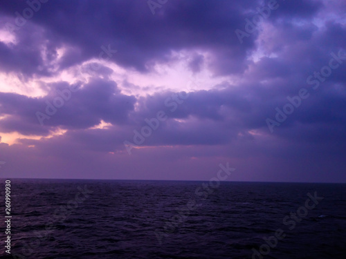 Fototapeta Naklejka Na Ścianę i Meble -  Wind and waves, dark clouds, and boat sights on the sea captured on a cruise ship