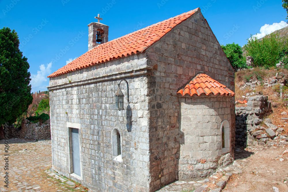 Old brick chapel in the Old Bar fortress, Montenegro. Ancient building with a roof of red tiles.