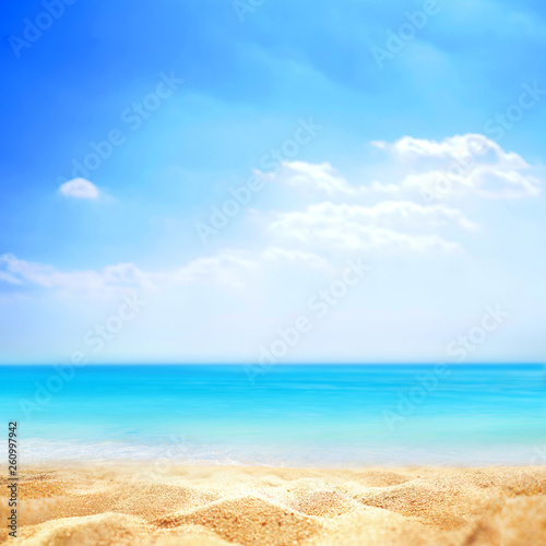 Summer background, nature of tropical golden beach with blue sky and white clouds. Golden sand beach close-up and turquoise water sea, landscape. Copy space, summer vacation concept.