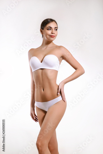 Beauty perfect slim body: fit girl in underwear. Beautiful and healthy woman posing at white background. Sport, wellness, fitness, diet, weight loss and healthcare concept.