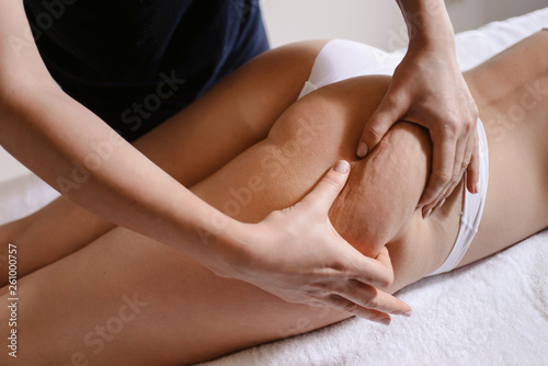 Anti cellulite massage for young woman in beauty salon. Perfect skin fat burning beauty concept photo