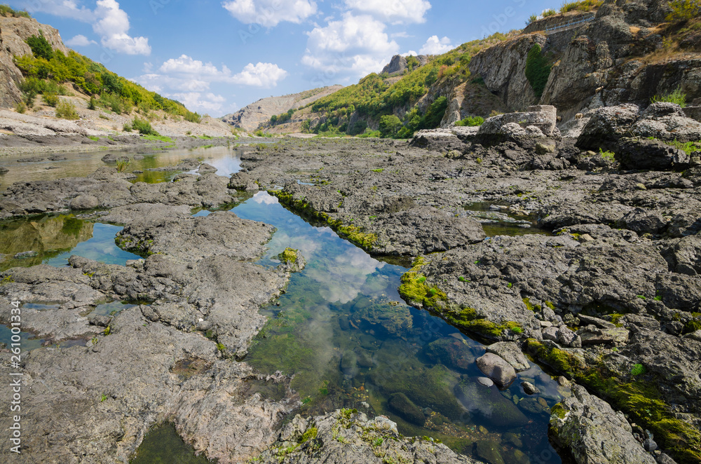 Abrasive basalt rocks at the bottom of the Arda River behind the Studen Kladenets dam, Bulgaria