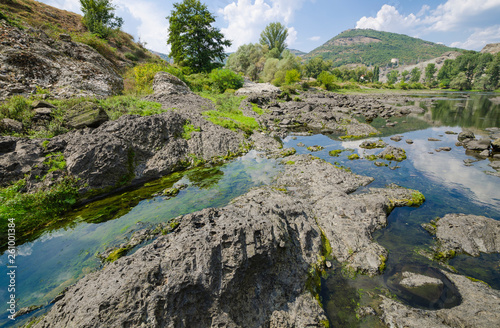 Fototapeta Naklejka Na Ścianę i Meble -  Abrasive basalt rocks at the bottom of the Arda River behind the Studen Kladenets dam, Bulgaria