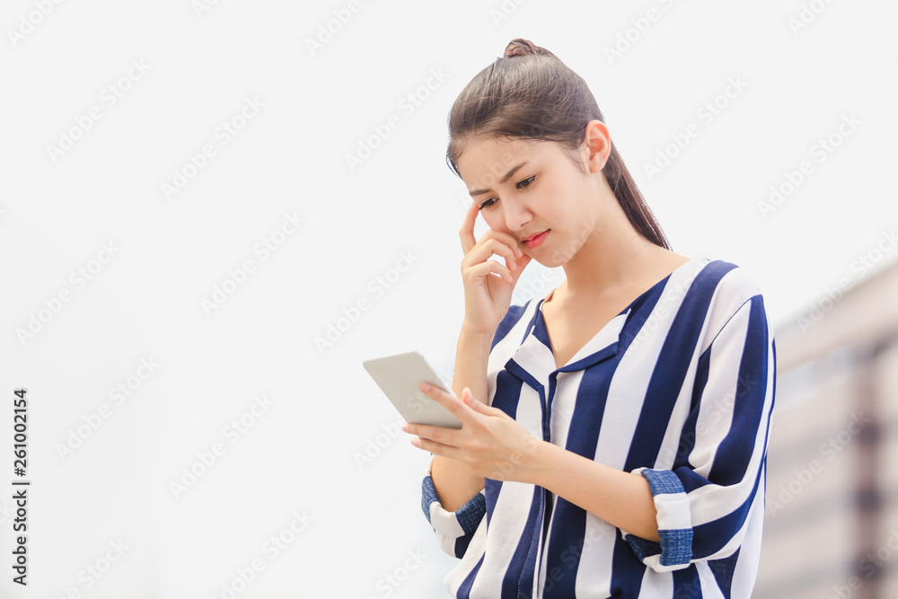 Outdoor lifestyle young woman looking on smartphone. Business concept Outdoor lifestyle young woman looking on smartphone. Business concept