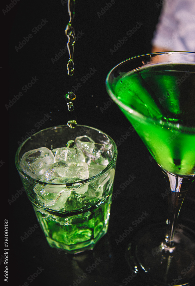 Green highball and martini cocktail on black bacground. Green highball and martini cocktail on black bacground.